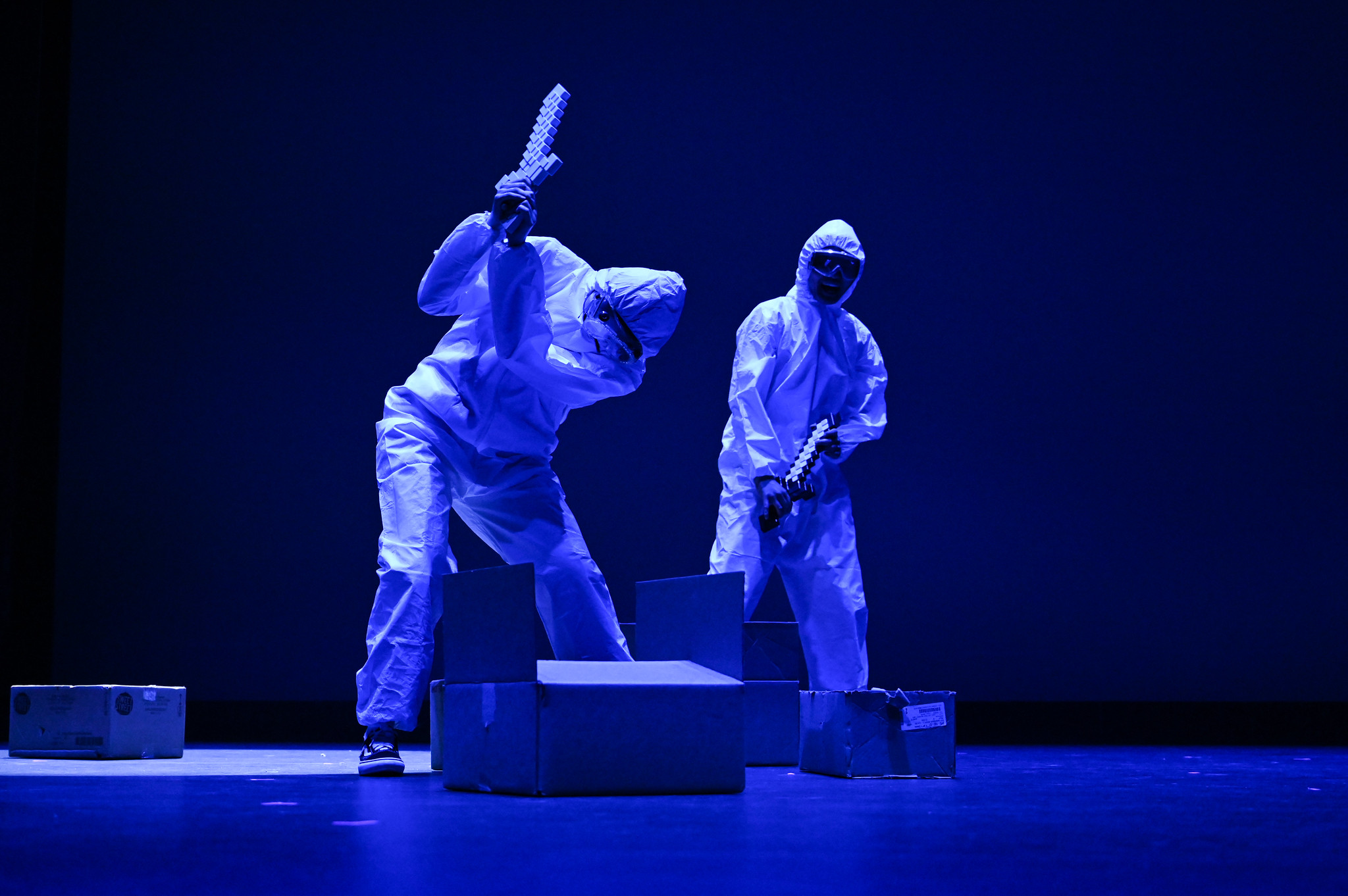 Two characters breaking boxes with minecraft swords.