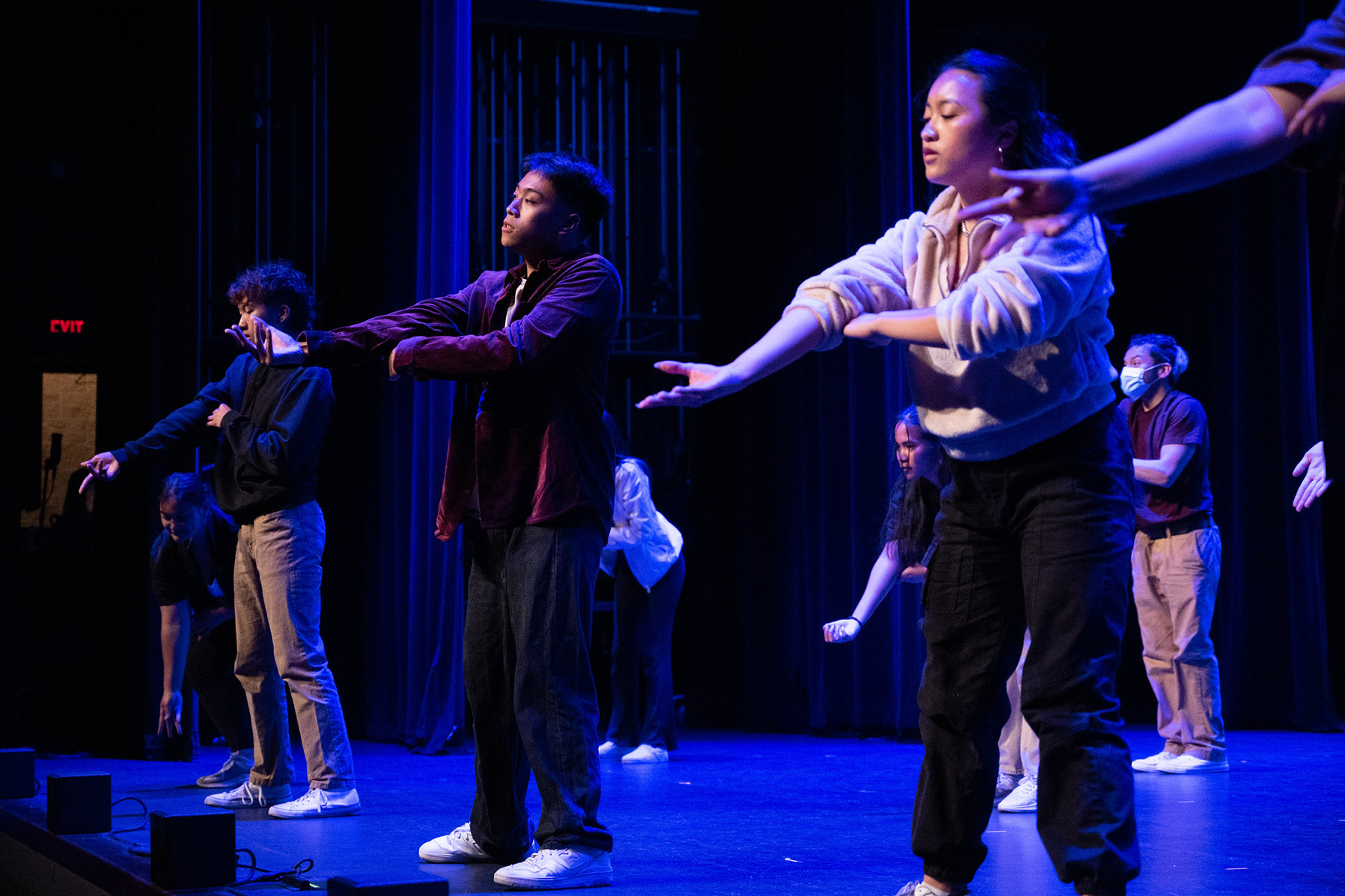 Modern dancers posing on stage.